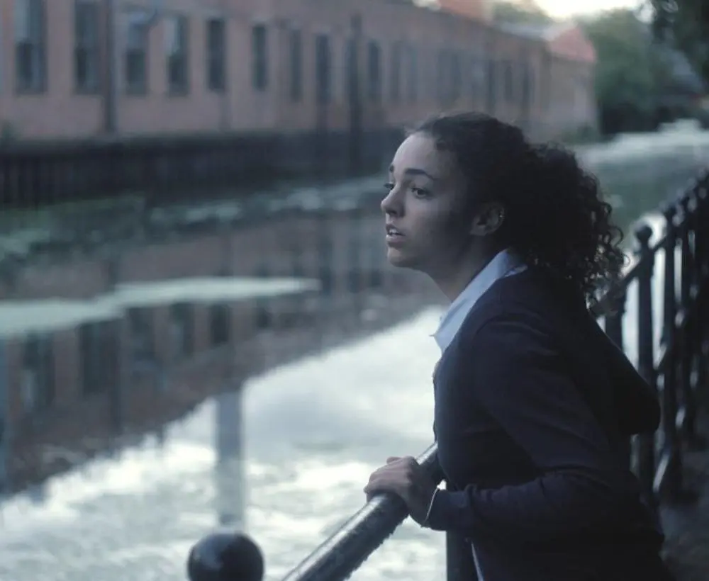 young person by a canal - still from the film