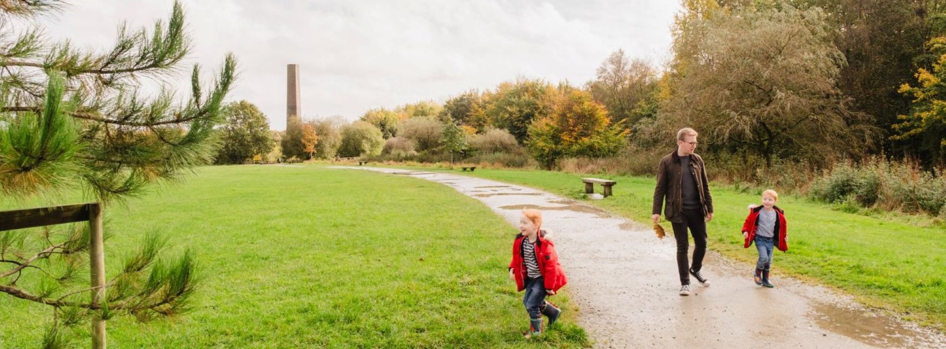 man walking in the countryside with two young boys