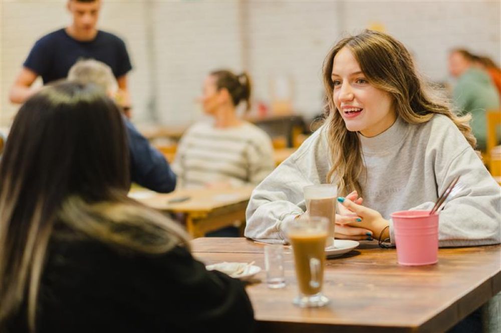 young people drinking coffee and chatting