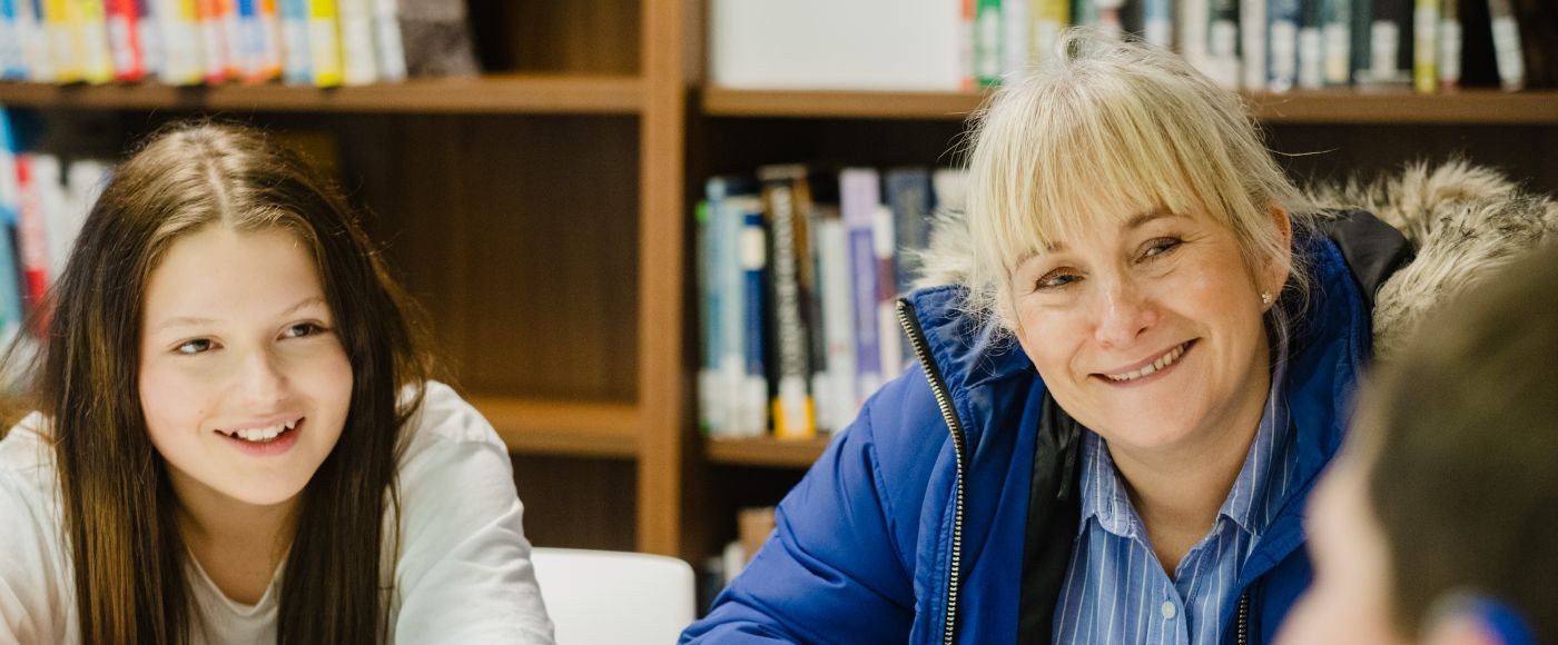 woman having a conversation with two young people